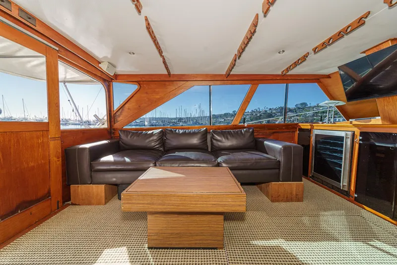 Slide: The Image of Interior of a 1974 Pacemaker Sportfisher yacht with leather sofa and wooden table. - 11