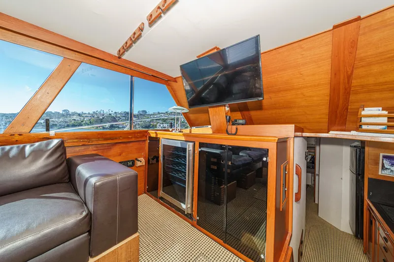 Slide: The Image of Interior of a 1974 Pacemaker Sportfisher yacht with leather sofa and TV. - 13