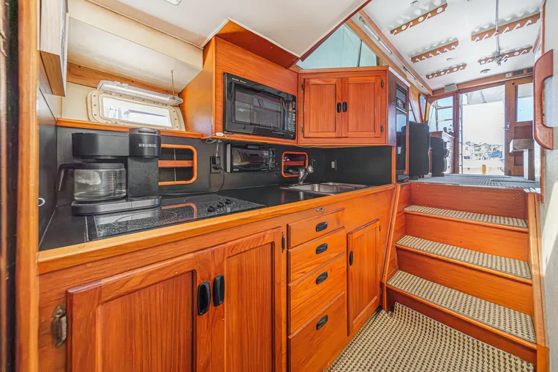 Slide: The Image of Interior of a 1974 Pacemaker Sportfisher yacht with wooden cabinetry. - 14