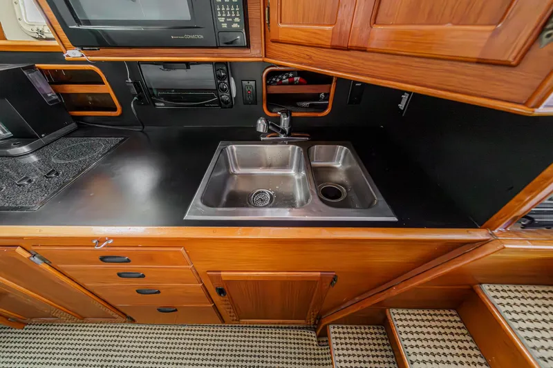 Slide: The Image of Kitchen area on a 1974 Pacemaker Sportfisher boat. - 16