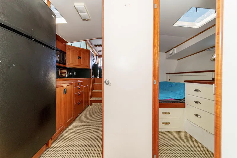Slide: The Image of Interior of a 1974 Pacemaker Sportfisher yacht with kitchen and sleeping area. - 18