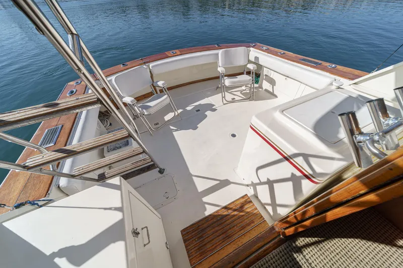 Slide: The Image of 1974 Pacemaker Sportfisher boat deck with seating area by the water. - 6
