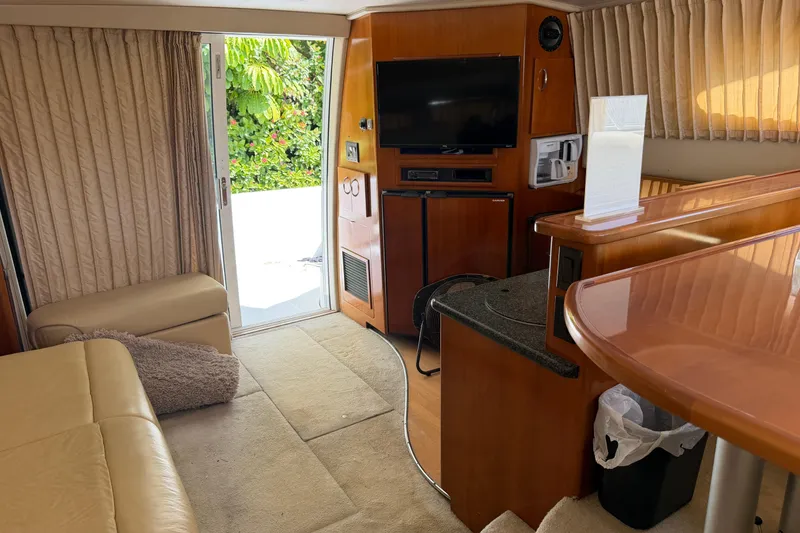 Slide: The Image of Luxurious interior of 2003 Carver 360 Sport Sedan with beige leather sofa and wooden cabinetry. - 13