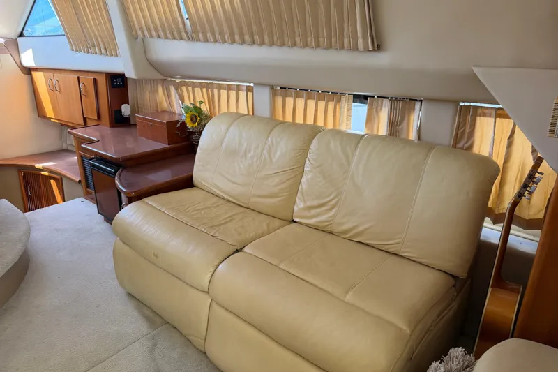 Slide: The Image of Interior of 2003 Carver 360 Sport Sedan with beige seating and curtains. - 14