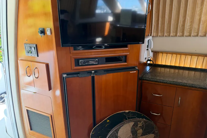 Slide: The Image of 2003 Carver 360 Sport Sedan kitchen with wood cabinets and granite countertops. - 16