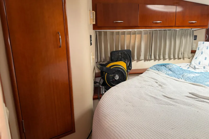 Slide: The Image of 2003 Carver 360 Sport Sedan interior with wood cabinetry and porthole window. - 26