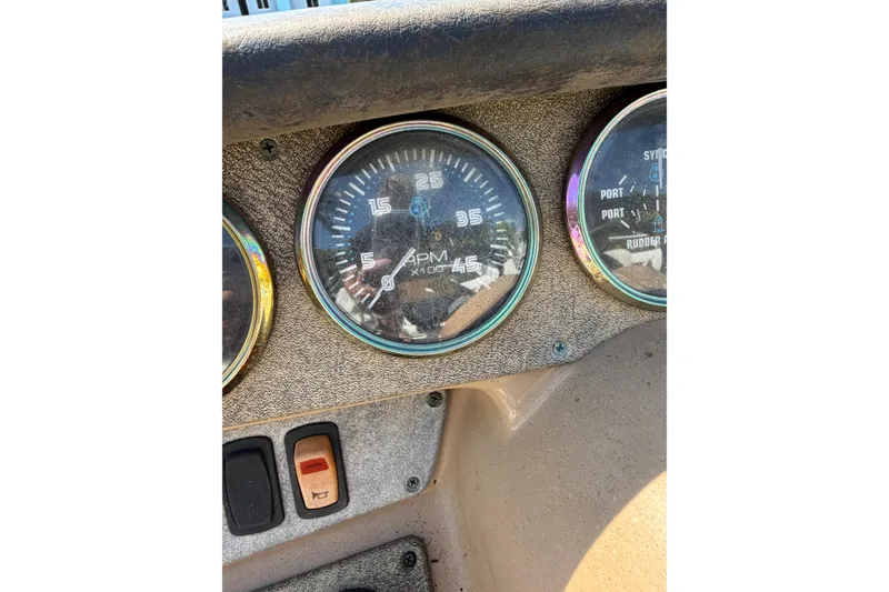 Slide: The Image of 2003 Carver 360 Sport Sedan dashboard with RPM and oil pressure gauges. - 39