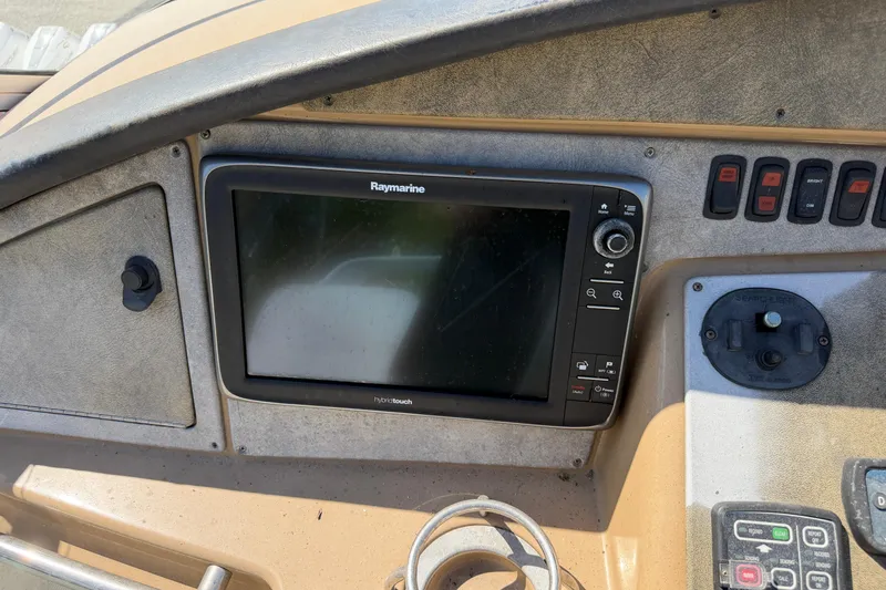Slide: The Image of 2003 Carver 360 Sport Sedan helm with steering wheel, gauges, and navigation equipment. - 9