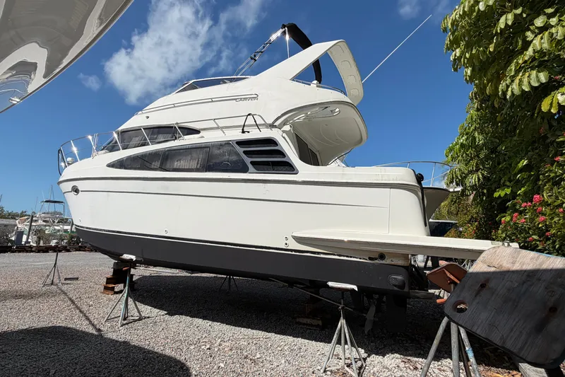 Slide: The Image of 2003 Carver 360 Sport Sedan yacht on stands, clear sky background. - 2