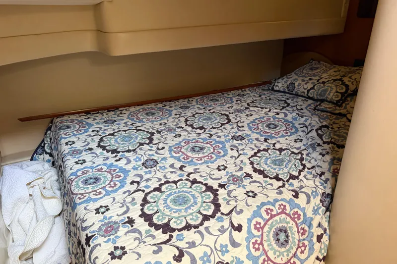 Slide: The Image of Interior of 2003 Carver 360 Sport Sedan with wood cabinets and patterned bedding. - 22