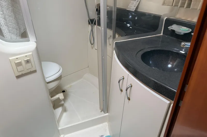 Slide: The Image of 2003 Carver 360 Sport Sedan bathroom with shower, glass doors, and modern fixtures. - 29