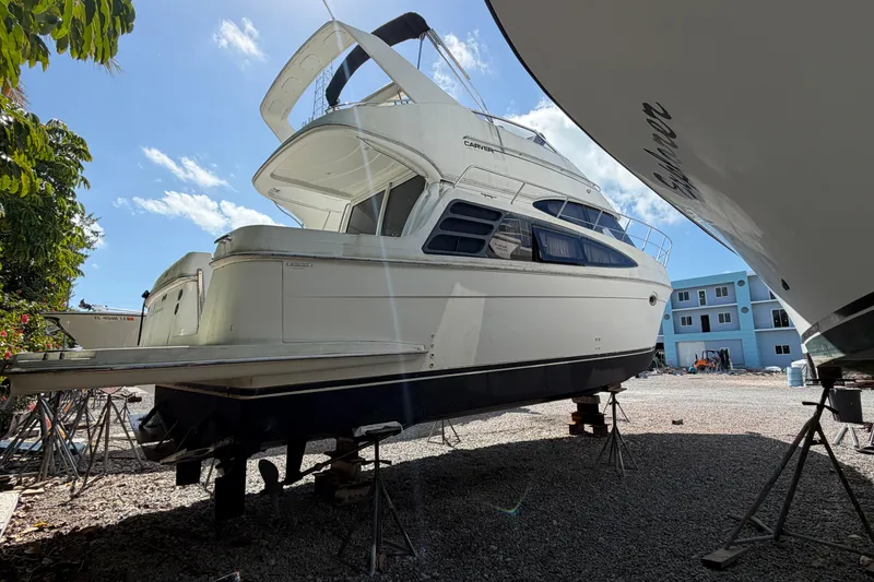 Slide: The Image of 2003 Carver 360 Sport Sedan yacht on dry dock under clear blue sky. - 3