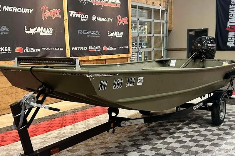 Slide: The Image of 2024 Lowe L1448 Jon boat on display with Mercury motor in showroom. - 10