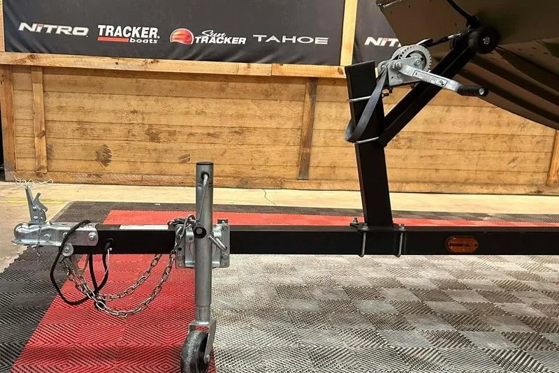 Slide: The Image of 2024 Lowe L1448 Jon boat trailer hitch and winch in showroom setting. - 14