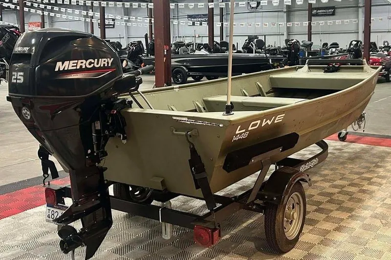 Slide: The Image of 2024 Lowe L1448 Jon boat with Mercury 25 engine on trailer in showroom. - 3