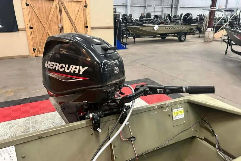 Slide: The Image of 2024 Lowe L1448 Jon boat with Mercury outboard motor in showroom. - 4