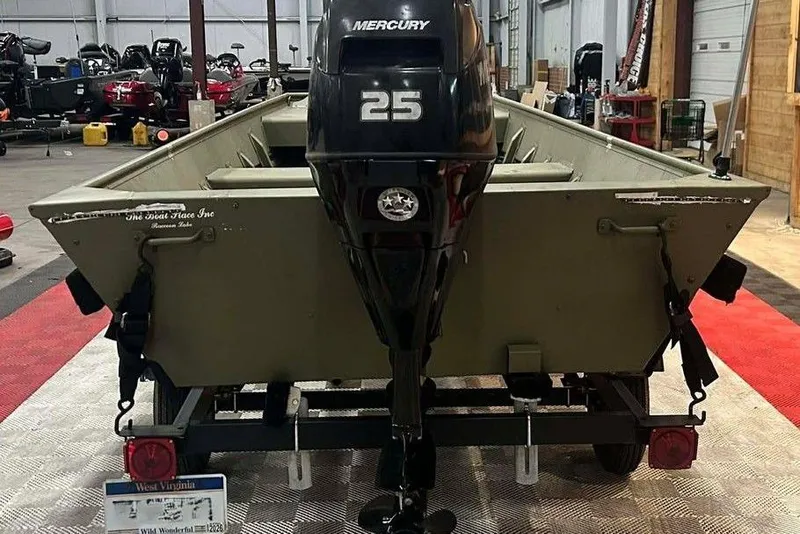 Slide: The Image of 2024 Lowe L1448 Jon boat with Mercury 25 engine in a showroom. - 6