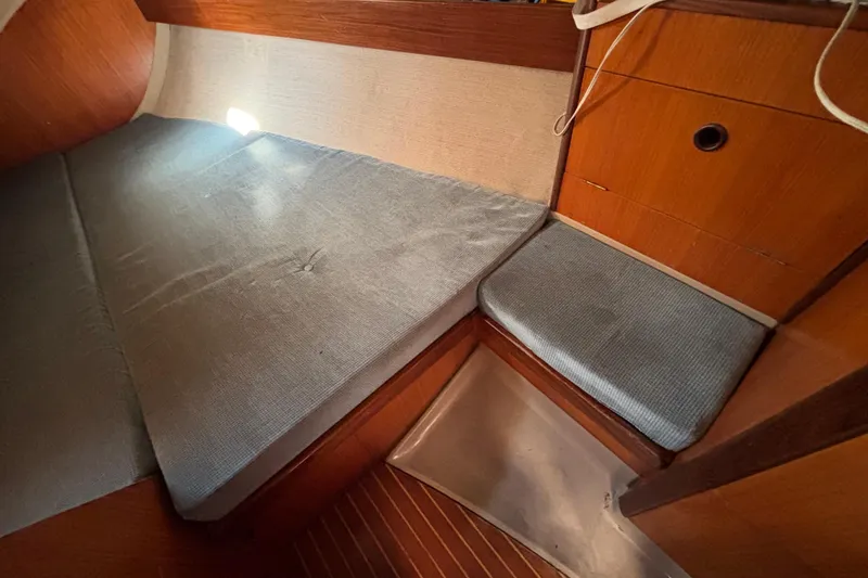 Slide: The Image of Cozy cabin interior of 1986 Beneteau First 375 sailboat with blue cushions. - 10