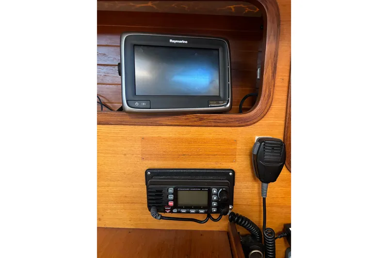 Slide: The Image of Navigation equipment on 1986 Beneteau First 375 sailboat, featuring Raymarine display and radio. - 11