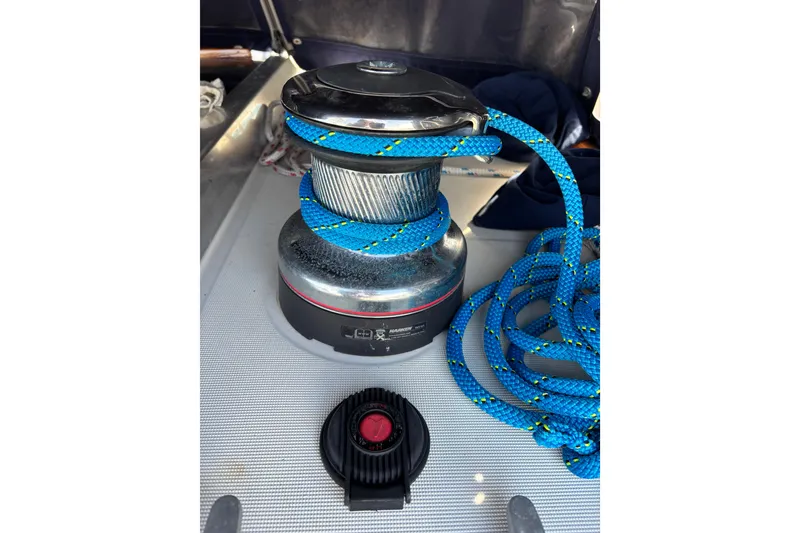 Slide: The Image of Winch with blue rope on 1986 Beneteau First 375 sailboat deck. - 14