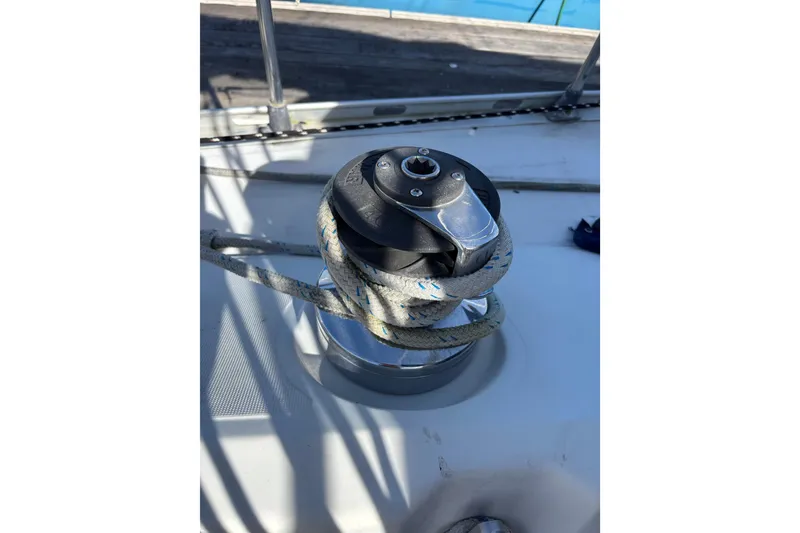 Slide: The Image of Winch on 1986 Beneteau First 375 sailboat deck with rope coiled around. - 16