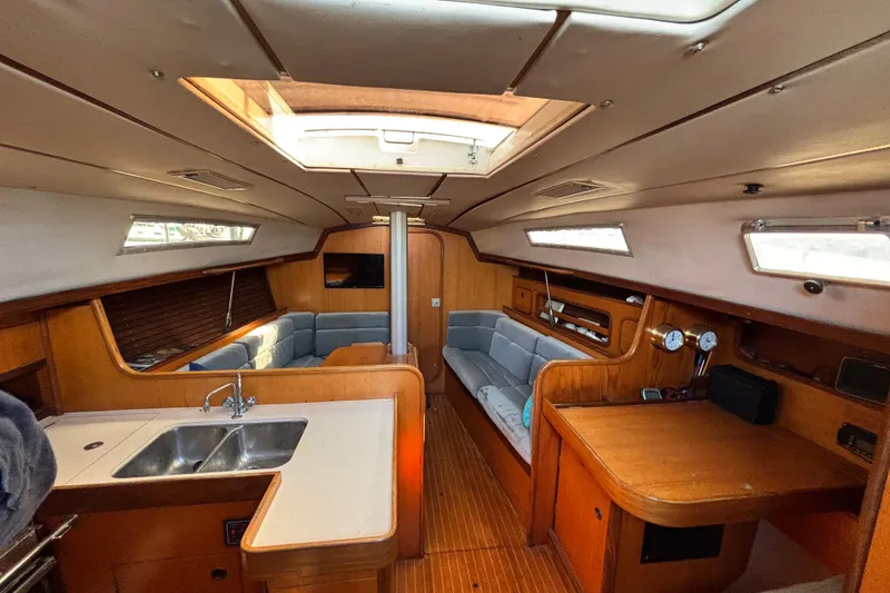 Slide: The Image of Interior of 1986 Beneteau First 375 sailboat with wood finish and cozy seating area. - 4