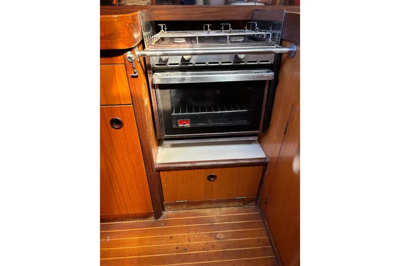 Slide: The Image of Galley oven in 1986 Beneteau First 375 sailboat, featuring wooden cabinetry. - 5