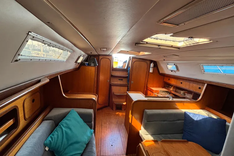 Slide: The Image of Interior of 1986 Beneteau First 375 sailboat with wood finish and seating area. - 7