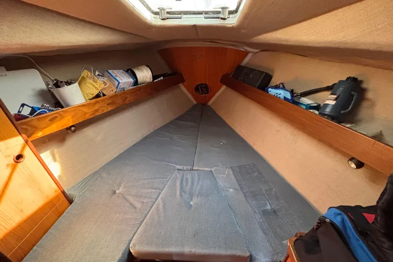 Slide: The Image of Interior cabin of 1986 Beneteau First 375 sailboat with storage and bedding. - 8