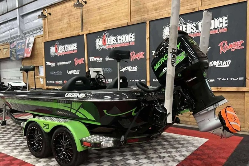 Slide: The Image of 2018 Legend Boats V20 with Mercury engine in showroom setting. - 3