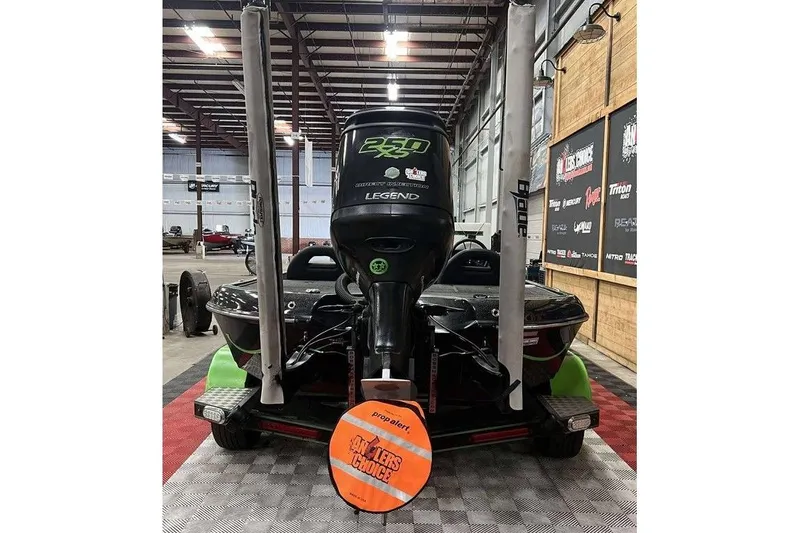 Slide: The Image of 2018 Legend Boats V20 in a showroom, featuring a powerful outboard motor. - 4