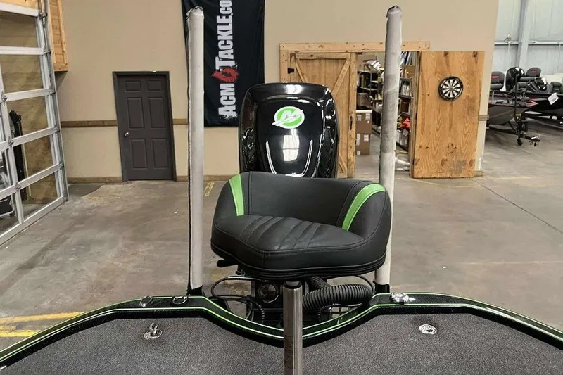 Slide: The Image of 2018 Legend Boats V20 interior with black and green seat in a garage setting. - 8