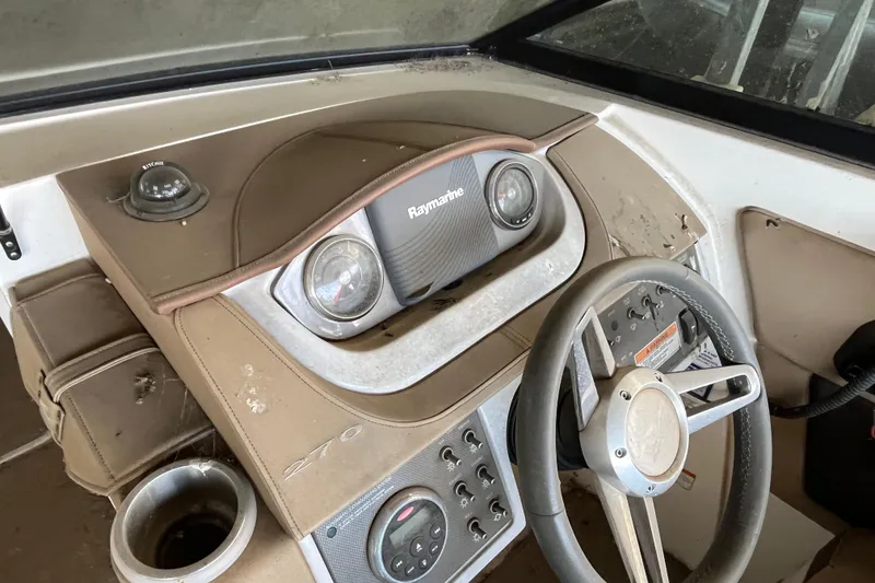 Slide: The Image of 2016 Sea Ray 270 Sundeck dashboard with steering wheel and navigation instruments. - 10