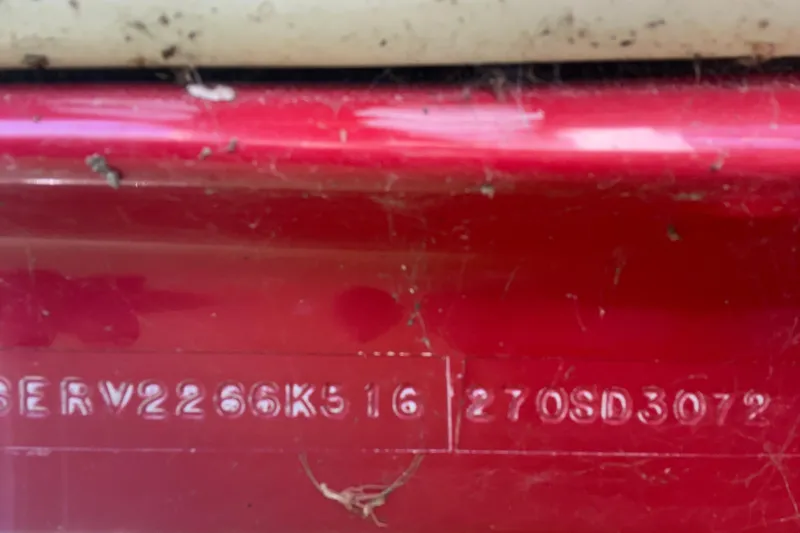 Slide: The Image of 2016 Sea Ray 270 Sundeck hull identification number on red surface. - 11