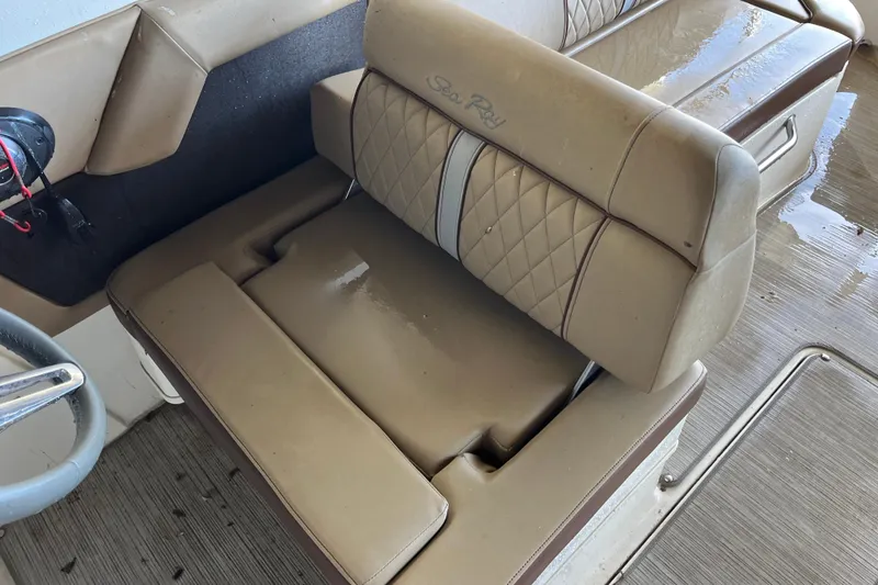 Slide: The Image of 2016 Sea Ray 270 Sundeck interior with tan leather seating and steering wheel. - 20