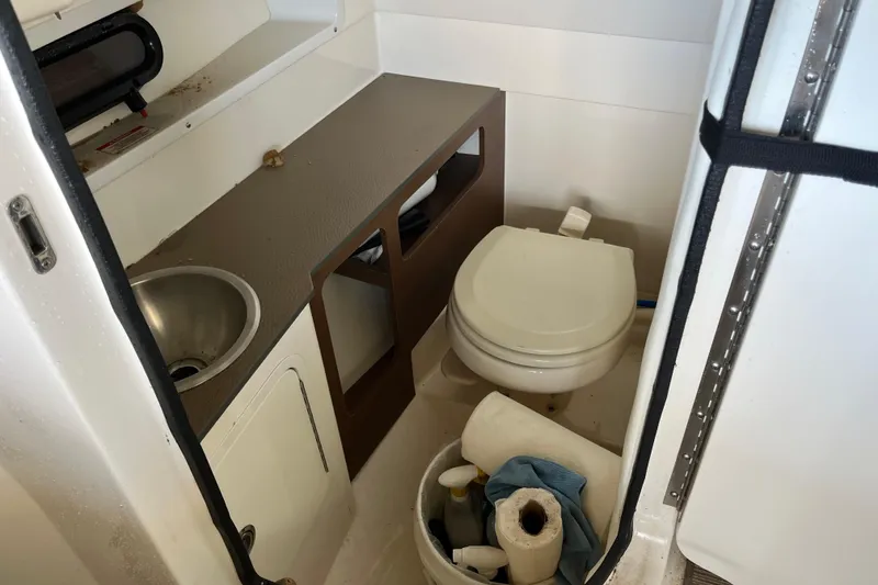 Slide: The Image of Interior of 2016 Sea Ray 270 Sundeck boat bathroom with sink and toilet. - 22