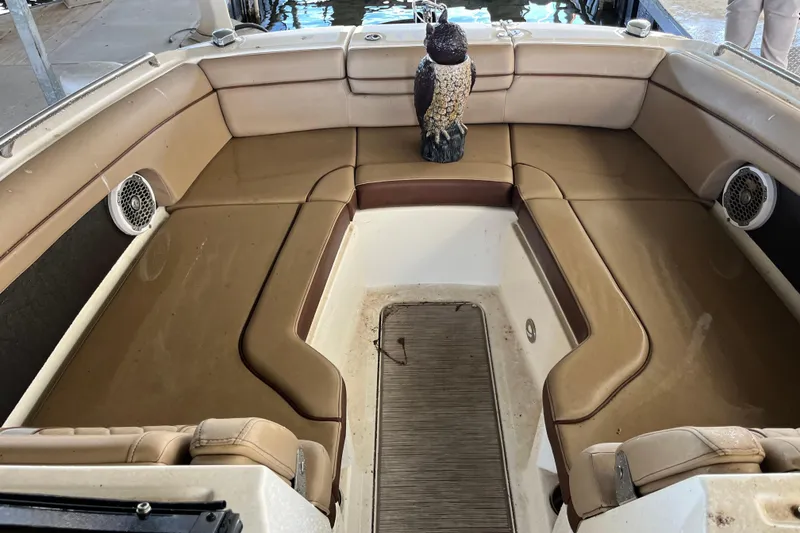 Slide: The Image of 2016 Sea Ray 270 Sundeck interior with tan seating and decorative owl statue. - 24