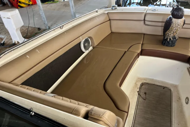 Slide: The Image of 2016 Sea Ray 270 Sundeck interior with tan seating and decorative owl statue. - 25