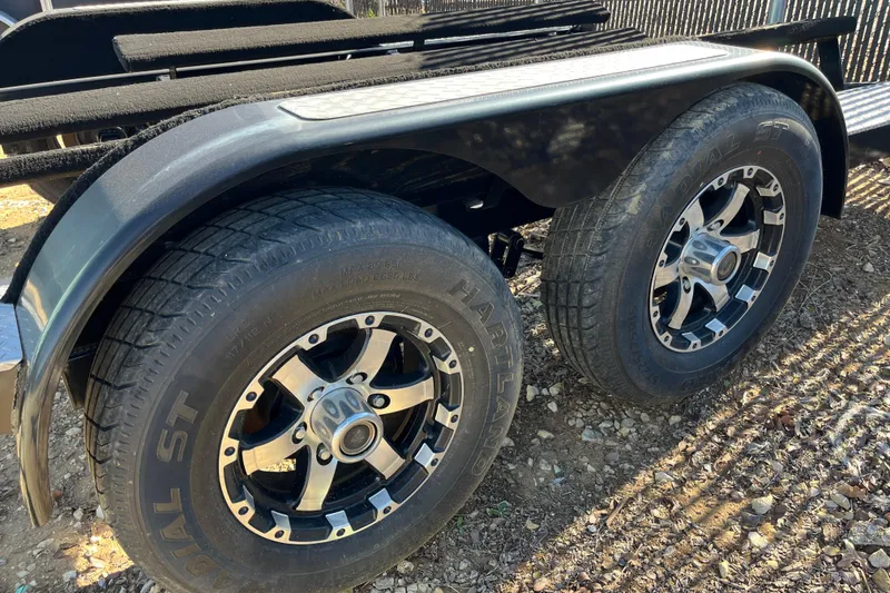 Slide: The Image of Trailer wheels for 2016 Sea Ray 270 Sundeck boat, featuring black and silver rims. - 30