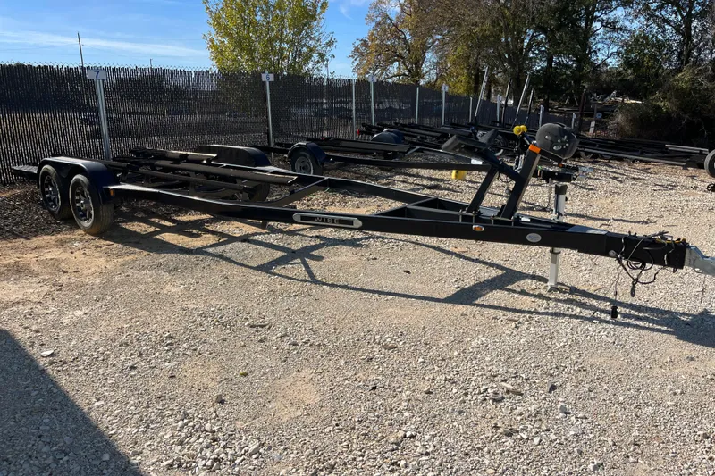 Slide: The Image of Trailer for 2016 Sea Ray 270 Sundeck on gravel lot, surrounded by trees and fencing. - 32