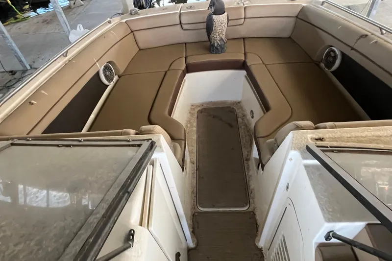 Slide: The Image of 2016 Sea Ray 270 Sundeck interior with tan seating and decorative owl. - 8