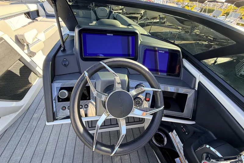 Slide: The Image of Steering console of 2026 Avalon Excalibur boat with dual Simrad displays and joystick controls. - 33