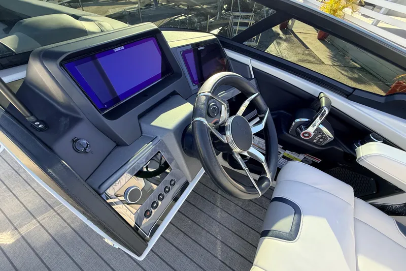 Slide: The Image of Interior of 2026 Avalon Excalibur boat with modern dashboard and steering wheel. - 36