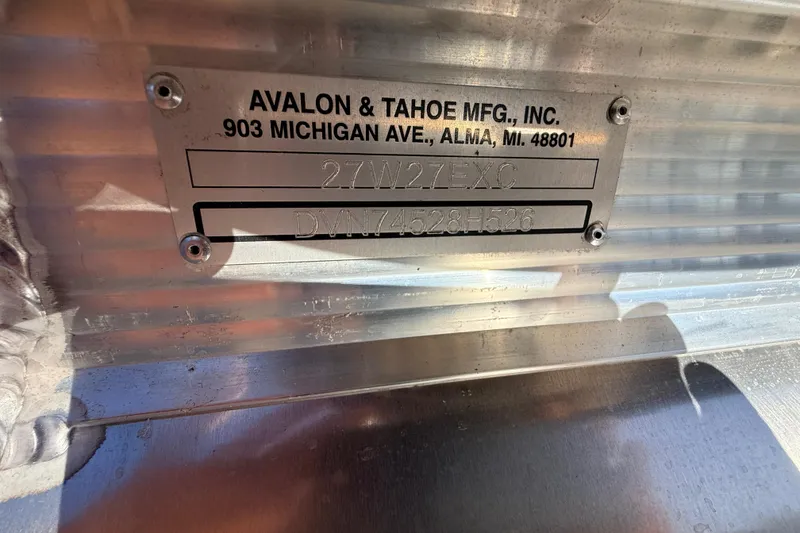 Slide: The Image of Metal identification plate on 2026 Avalon Excalibur boat, featuring manufacturing details and serial number. - 40