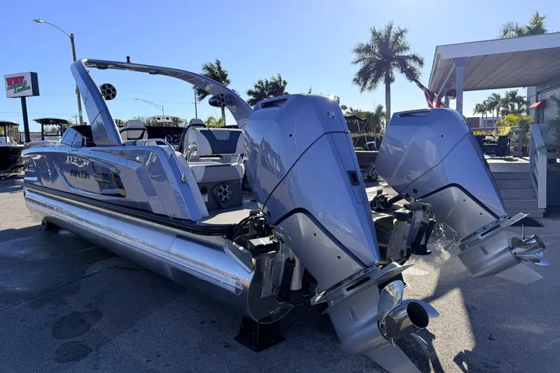 Slide: The Image of 2026 Avalon Excalibur boat with twin Mercury 425hp engines, parked outdoors. - 9