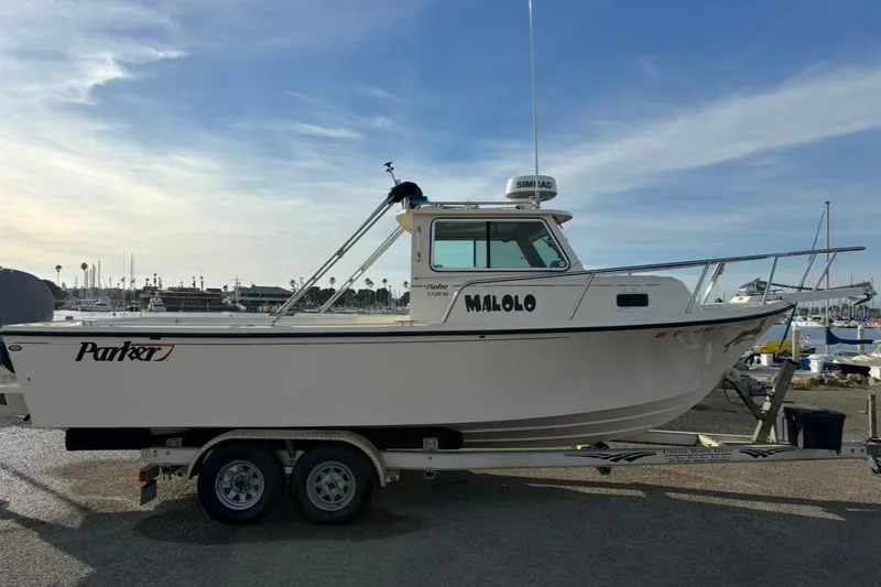 Slide: The Image of 2008 Parker 2320 SL Sport Cabin boat on trailer at marina, side view. - 0