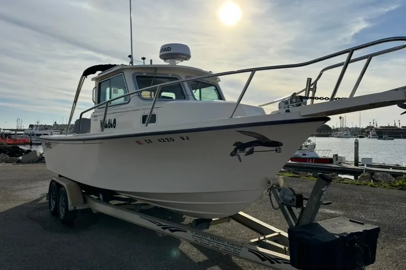 Slide: The Image of 2008 Parker 2320 SL Sport Cabin boat on trailer at marina, sunny day. - 1