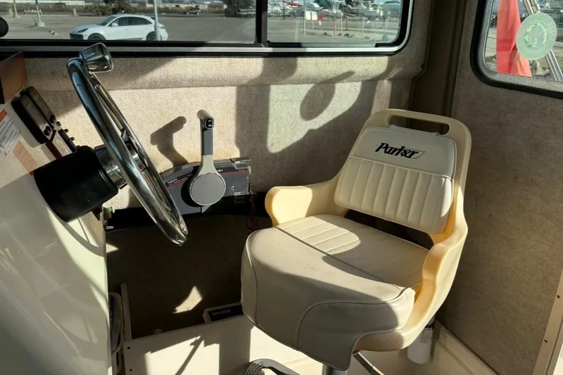 Slide: The Image of Interior of 2008 Parker 2320 SL Sport Cabin with steering wheel and branded seat. - 13