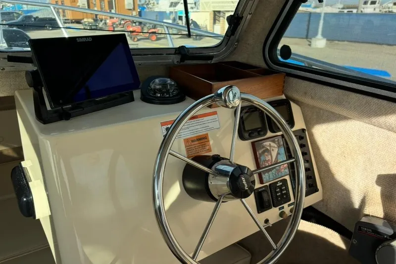 Slide: The Image of Interior of 2008 Parker 2320 SL Sport Cabin with steering wheel and navigation equipment. - 14
