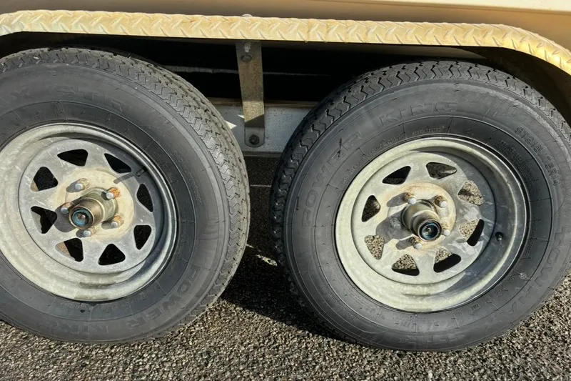 Slide: The Image of Trailer wheels of a 2008 Parker 2320 SL Sport Cabin on asphalt surface. - 22
